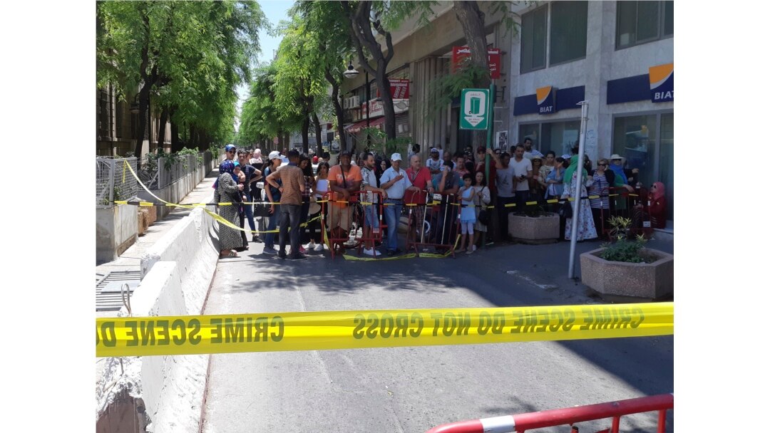 People are prevented to enter a security area after an explosion in Tunis, Thursday June 27, 2019.