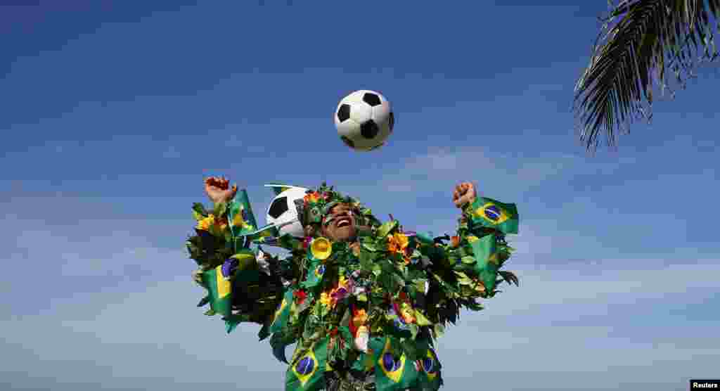 A Brazilian football fan plays with a soccer ball on a beach in Rio de Janeiro. The 2014 World Cup starts in Brazil on June 12, 2014.