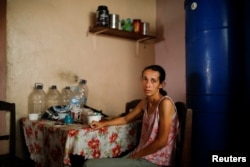 Yaneidi Guzman, 38, poses for a picture at her home in Caracas, Venezuela, Feb. 17, 2019. Guzman has lost a third of her weight over the past three years as Venezuela's economic collapse made food unaffordable.