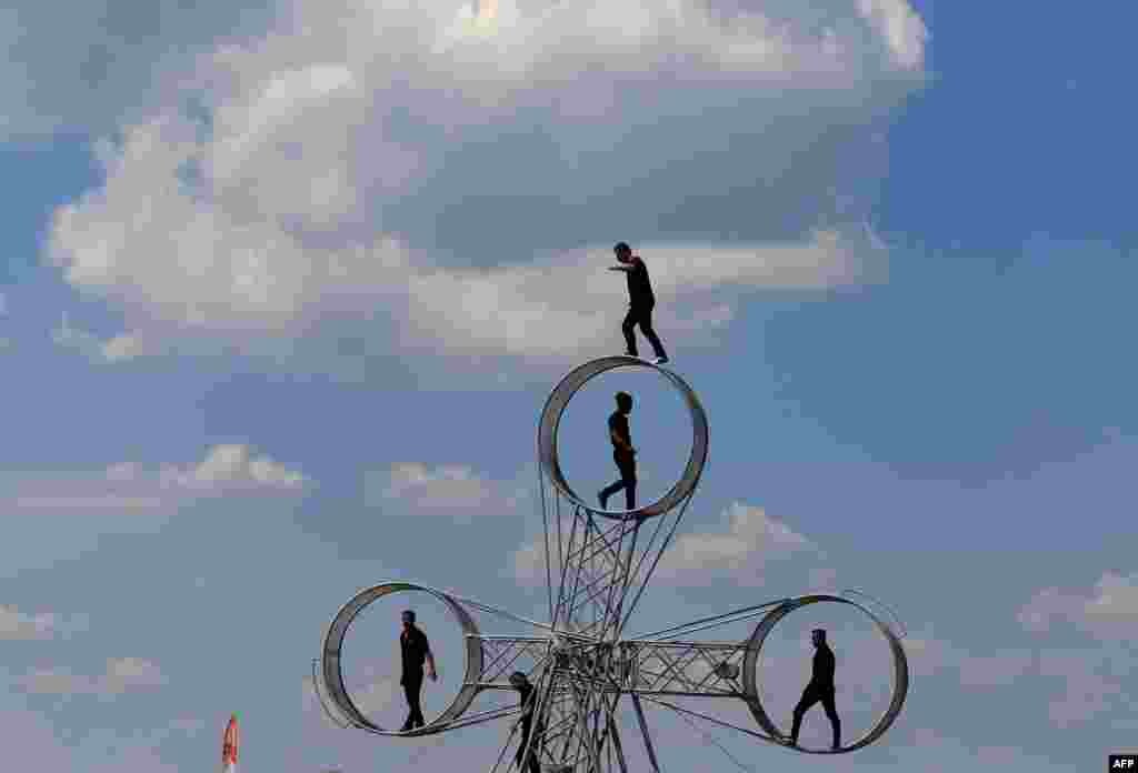 Artists of the Hungarian National Circus perform on the shore of the Lake Balaton before the Night of the Circuses in Balatonlelle, July 14, 2018.