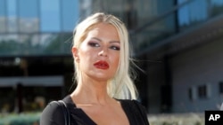 FILE - Chloe Goins, a model who claims entertainer Bill Cosby drugged and sexually abused her at the Playboy Mansion in 2008, appears before reporters outside Los Angeles police headquarters after meeting police investigators in Los Angeles, Jan. 14, 2015.