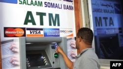 Man uses first-ever ATM cash withdrawal machine in the country, Mogadishu, on Oct. 7, 2014.