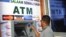 Man uses first-ever ATM cash withdrawal machine in the country, Mogadishu, on Oct. 7, 2014.