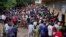 Hundreds of Congolese voters who have been waiting at the St. Raphael school in the Limete district of Kinshasa Sunday Dec. 30, 2018, storm the polling stations after the voters listings were finally posted five hours after the official start of voting. 