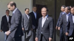 President Barack Obama, center, walks out with leaders of ASEAN, the 10-nation Association of Southeast Asian Nations, for the official group photo, Tuesday, Feb. 16, 2016, at the Annenberg Retreat at Sunnylands in Rancho Mirage, Calif. President Obama an