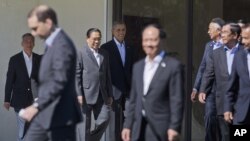 President Barack Obama, center, walks out with leaders of ASEAN, the 10-nation Association of Southeast Asian Nations, for the official group photo, Tuesday, Feb. 16, 2016, at the Annenberg Retreat at Sunnylands in Rancho Mirage, Calif. President Obama an