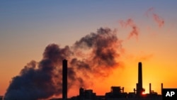 Dave Johnson coal-fired power plant is silhouetted against the morning sun in Glenrock, Wyo.
