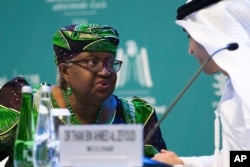 FILE — World Trade Organization Director-General Ngozi Okonjo-Iweala talks to Emirati Minister of State for Foreign Trade Thani bin Ahmed al-Zeyoudi on stage at a WTO summit in Abu Dhabi, United Arab Emirates, February 26, 2024.