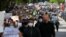 Protesters carry signs at a rally following the death in Minneapolis police custody of George Floyd, in Boston, Massachusetts, May 31, 2020. 