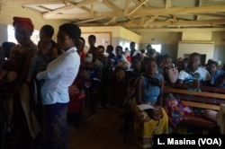 Mothers queue to have their children vaccinated against malaria at Likuni Community Hospital in Lilongwe, Malawi.