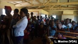 FILE - Mothers queue to have their children vaccinated against malaria at Likuni Community Hospital in Lilongwe, Malawi.