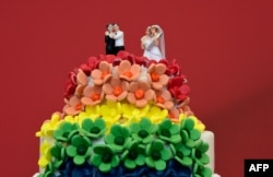 A wedding cake in rainbow colors and decorated with figurines of two women and two men is pictured in Berlin, June 30, 2017.