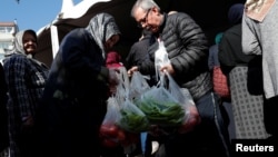 People shop at a tent set up by the municipality in the Bayrampasa district of Istanbul, Turkey, Feb. 11, 2019.