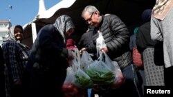 People shop at a tent set up by the municipality in the Bayrampasa district of Istanbul, Turkey, Feb. 11, 2019.