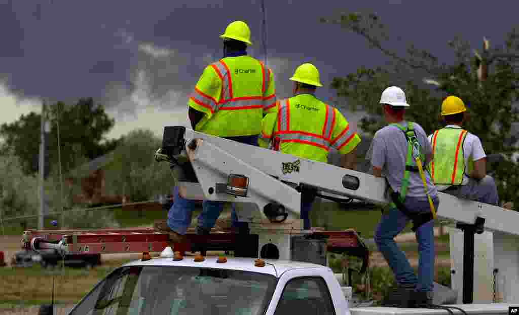 Charter cable workers keep a close eye on an approaching storm as sirens sound signaling a possible tornado in Athens, Alabama. (AP)