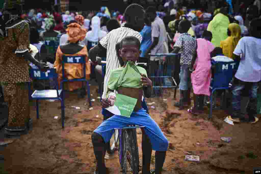 A young boy holds a flyer of Malian opposition candidate for the presidential elections Soumaila Cisse during a rally in Koulikoro. Mali&#39;s incumbent president Ibrahima Boubacar Keita, who took office in 2013, and opposition frontrunner Soumaila Cisse are expected to be the two main candidates in the July 29 polls out of a field of 24 hopefuls