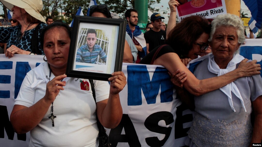 Mother of Jeisson Chavarria, who was killed in a recent protest over reforms of pension plans of Nicaraguan Social Security Institute (INSS), holds a photo during a protest organized by the Mothers of April Movement to demand from President Daniel Ortega's government justice for their relatives in Managua, Nicaragua May 10, 2018. 