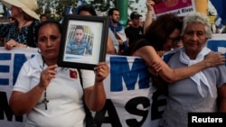 Mother of Jeisson Chavarria, who was killed in a recent protest over reforms of pension plans of Nicaraguan Social Security Institute (INSS), holds a photo during a protest organized by the Mothers of April Movement to demand from President Daniel Ortega's government justice for their relatives in Managua, Nicaragua May 10, 2018. 