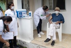 Aloysio Zaluar, 84, is injected with a dose of the Pfizer COVID-19 vaccine during a booster shot campaign for elderly residents in long-term care institutions in Rio de Janeiro, Brazil, Sept. 1, 2021.