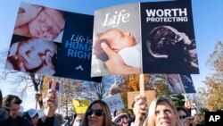 Anti-abortion protesters demonstrate in front of the U.S. Supreme Court, Dec. 1, 2021, in Washington.