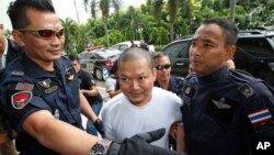 FILE - Former Buddhist monk Wirapol Sukphol is escorted by officials from the Department of Special Investigation to the prosecutor's office in Bangkok, Thailand, July 20, 2017.