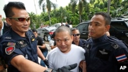 Fugitive ex-monk Wirapol Sukphol is escorted by the Department of Special Investigation officials to the prosecutor's office in Bangkok, Thailand, July 20, 2017.