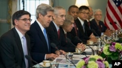 Treasury Secretary Jacob Lew, left, Secretary of State John Kerry, second from left, and others, participate in the Joint Session on Climate Change with Chinese delegation headed by Chinese Vice Premier Wang Yang, July 10, 2013.
