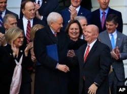 Chairman of the Senate Finance Committee Orrin Hatch (Front-L), Rep. Diane Black (Back-L), House Financial Services Committee Chairman Jeb Hensarling (Back-R), and other lawmakers applaud as House Ways and Means Committee Chairman Kevin Brady is acknowle