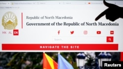 A girl points at word north at the official web site of Macedonian government with country new name Republic of North Macedonia in Skopje, Macedonia, Feb. 12, 2019.