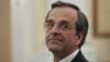 Newly appointed Greek Prime Minister Antonis Samaras smiles before a swearing in ceremony at the presidential palace in Athens, June 20, 2012. 