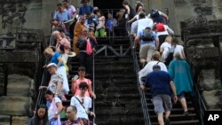 Tourists visit the Angkor Wat temple in Siem Reap, Cambodia, Wednesday, March 14, 2018. The temples were built between the 9th and 15th centuries. (AP Photo/Heng Sinith)