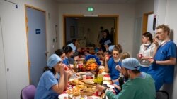 Doctors and nurses share a Christmas Eve meal in the COVID-19 intensive care unit at la Timone hospital in Marseille, southern France, Dec. 24, 2021.
