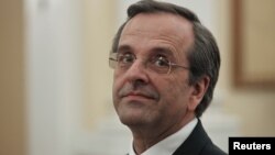 Newly appointed Greek Prime Minister Antonis Samaras smiles before a swearing in ceremony at the presidential palace in Athens, June 20, 2012. 