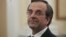 Newly appointed Greek Prime Minister Antonis Samaras smiles before a swearing in ceremony at the presidential palace in Athens, June 20, 2012. 