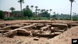 This undated photo released by the Egyptian Ministry of Antiquities, shows a large Roman bath and a chamber likely for religious rituals, that was recently discovered in the town of Mit Rahina, 20 kilometers, or 12 miles, south of Cairo, Egypt. 