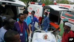 Medical personnel attend to a wounded child to be airlifted to the Turkish capital Ankara for treatment after Saturday's car bomb blast in Mogadishu, Somalia, Dec. 29, 2019. 