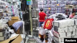 Para pekerja terlihat di sebuah toko di mal elektronik di Huaqiangbei Commercial Street, pasar untuk produsen China dan pembeli grosir internasional, di Shenzhen, Provinsi Guangdong, China, 6 September 2019. (Foto: Reuters)