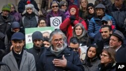 FILE - Ravi Ragbir, center, a citizen of Trinidad and Tobago and executive director of the New Sanctuary Coalition of New York City, speaks during a press conference held on his behalf as he fights deportation, Jan. 31, 2018, at New York City Hall. 
