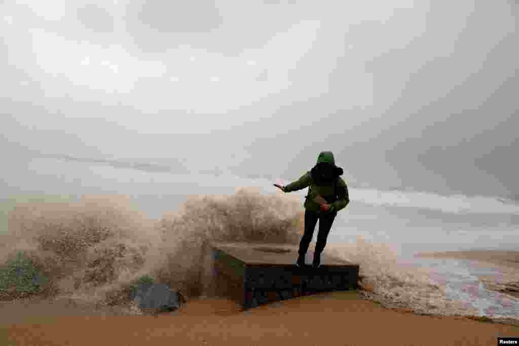 A woman is pictured during the storm Gloria on Maresme coast in Badalona, near Barcelona, Spain.