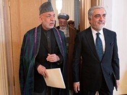 Former Afghan President Hamid Karzai, left, and chair of Afghanistan’s High Council for National Reconciliation Abdullah Abdullah leave the site of an Afghan peace conference in Moscow, Russia, March 18, 2021.