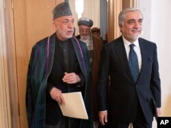Former Afghan President Hamid Karzai, left, and chair of Afghanistan’s High Council for National Reconciliation Abdullah Abdullah leave the site of an Afghan peace conference in Moscow, Russia, March 18, 2021.
