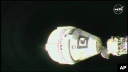 In this image from video provided by NASA, the unmanned Boeing Starliner capsule undocks as it pulls away from the International Space Station on Sept. 6, 2024. 