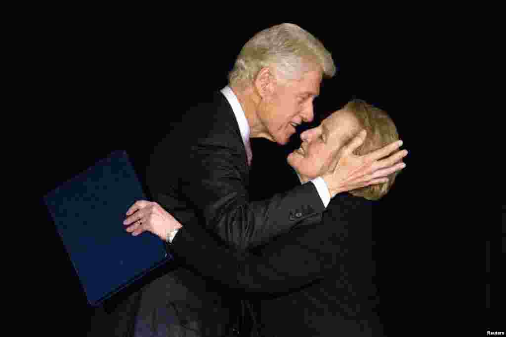 Former U.S. President Bill Clinton greets former Secretary of State Madeleine Albright on stage at the Annual Freedom Award Benefit Event hosted by the International Rescue Committee at the Waldorf-Astoria in New York, Nov. 6, 2013. This year's event honored philanthropist and businessman, George Soros.