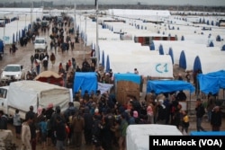 In the final weeks IS held a camp near Baghuz, Syria thousands of people evacuated the area, far more than any militaries or aid groups expected, pictured near Baghuz on March 10, 2019.