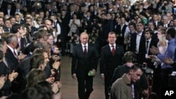 Russian President Dmitry Medvedev, right, and Prime Minister Vladimir Putin, left, seen as arrive at the United Russia party congress in Moscow, November 27, 2011.