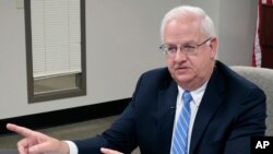 Kansas Revenue Secretary Mark Burghart discusses a new policy that will require out-of-state businesses to collect the state's sales tax on online sales to Kansas residents, during an interview with reporters, Aug. 7, 2019, in Topeka, Kan.