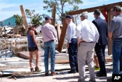 President Joe Biden speaks with Florida Senator Rick Scott in Keaton Beach, Florida, during his tour of areas impacted by Hurricane Helene, Oct. 3, 2024.