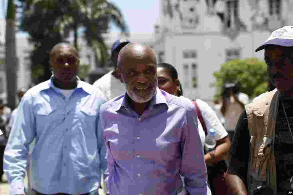 Haiti's President Rene Preval walks along a garden of the National Palace after a press conference in Port-au-Prince, Wednesday, June 30, 2010. Preval set Nov. 28 as the date voters will choose his successor, as leader of the earthquake-shattered Caribbea