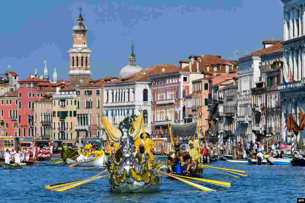 Rowers take part in the annual traditional gondolas and boats Historical Regatta (Regata Storica) on the Grand Canal in Venice, Italy.