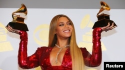 FILE - Beyonce shows off the awards she won for Best Urban Contemporary Album for 'Lemonade' and Best Music Video for 'Formation' at the 59th Annual Grammy Awards in Los Angeles, California, U.S. , Feb. 12, 2017.